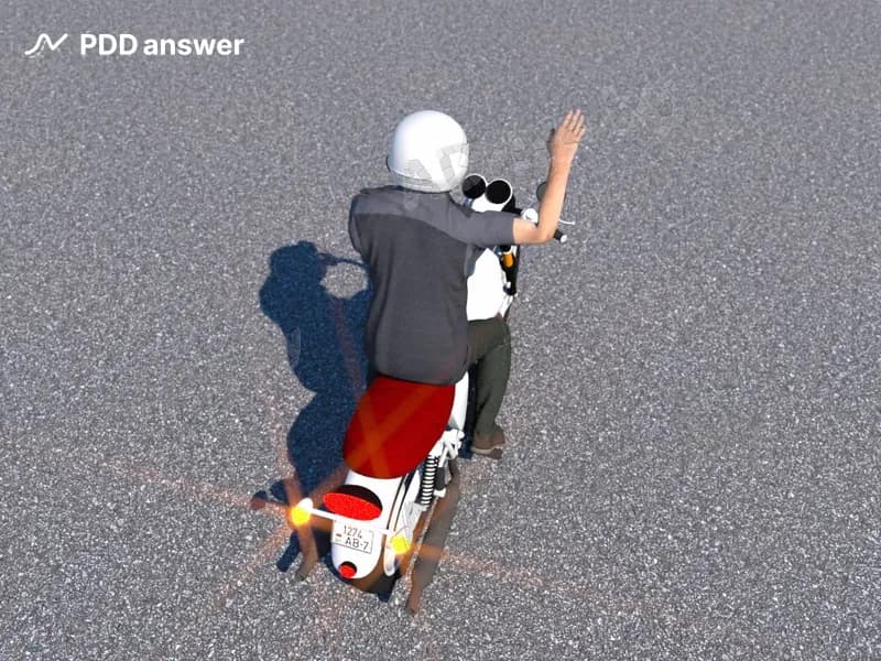 О чём может предупреждать водитель, подавая такой жест правой рукой?